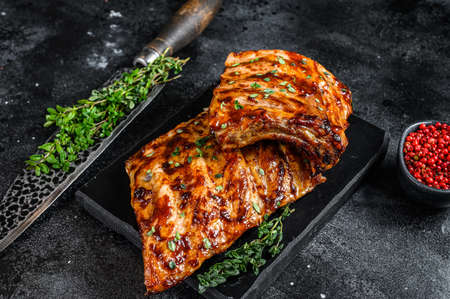 Barbecue pork rack spare ribs on a marble board. Black background. Top viewの写真素材