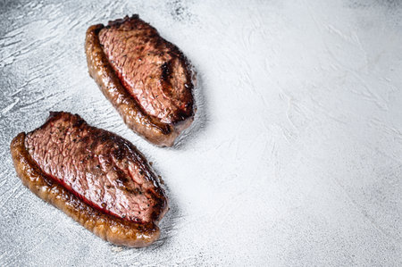 Grilled top sirloin cap or picanha steak. White background. Top view. Copy spaceの写真素材