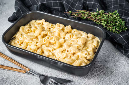 Mac and cheese american macaroni pasta with cheesy Cheddar sauce. White background. Top viewの写真素材