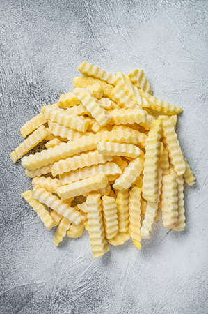 Frozen Crinkle French fries potatoes sticks. White background. Top viewの写真素材