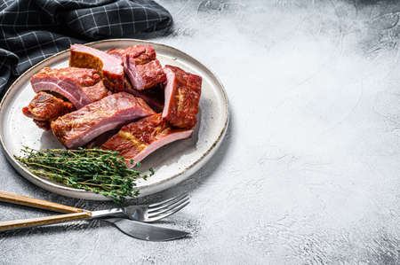 Sliced delicious smoked pork ribs in barbecue sauce. Gray background. Top view. Copy spaceの写真素材