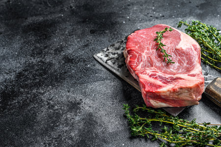 Raw beef club steak. Black ground. Top view. Copy spaceの写真素材