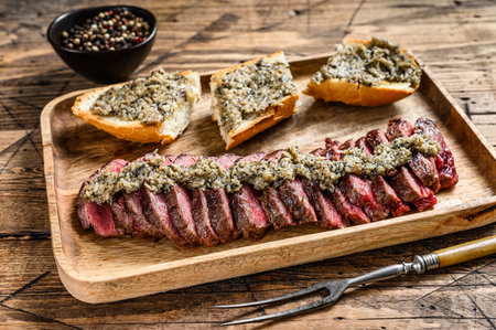Grilled machete or skirt beef steak. Wooden background. Top viewの写真素材