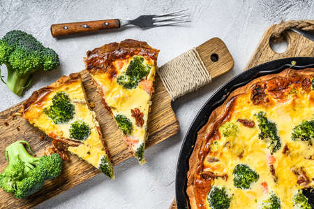 Homemade quiche tart with red fish and broccoli. White background. Top viewの写真素材