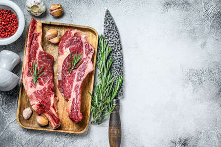 Raw cuts of beef marble meat on the bone. White background. Top view. Copy spaceの写真素材