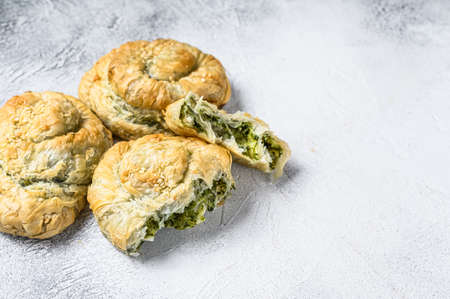 Spinach and feta cheese Twist greek Pie puff. White background. Top view. Copy space