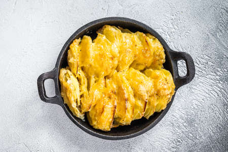 Baked Potato Gratin Dauphinois in a pan. White background. Top View