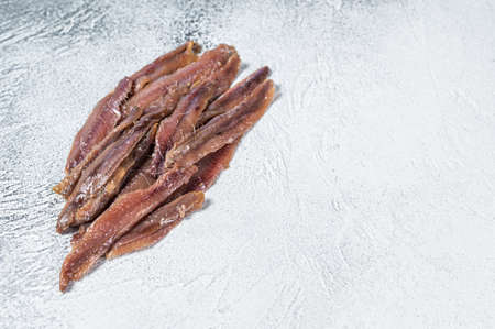 Canned Anchovies fish fillet in Olive Oil. White background. Top view. Copy spaceの写真素材