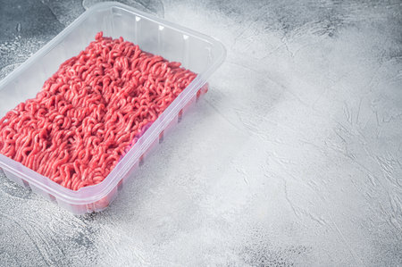 Fresh Raw mince beef and pork meat in vacuum packaging. White background. Top view. Copy spaceの写真素材