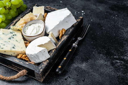 Assorted Cheese platter with Brie, Camembert, Roquefort, parmesan, blue cream cheese, grape and...