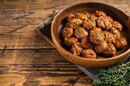 Baked Meatballs in tomato sauce from minced beef and pork meat with thyme in rustic wooden plate. background. Top view. Copy spaceの写真素材