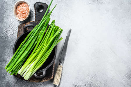 Raw Green onions chives. White background. Top view. Copy space