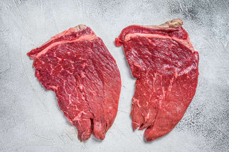 Raw fresh beef meat round steak. White background. Top view