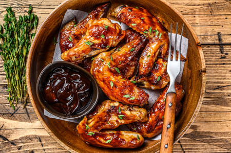 Grilled chicken wings with bbq sauce. wooden background. Top viewの写真素材
