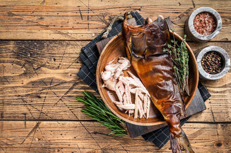 Fillet of Hot smoked fish pike perch or zander in a wooden plate with herbs. wooden background. Top view. Copy spaceの写真素材