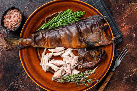 Fillet of Hot smoked fish perch in a rustic plate with thyme. Dark background. Top viewの写真素材