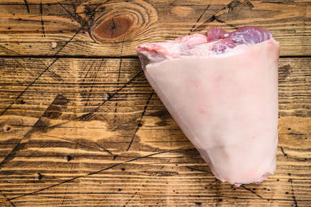 Raw pork knuckle meat on a kitchen table. Wooden background. Top view. Copy spaceの写真素材
