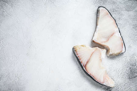 Raw Shark fish steaks on a kitchen table. White background. Top view. Copy spaceの写真素材
