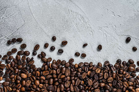 Roasted coffee beans on rustic table. White background. Top view. Copy spaceの写真素材