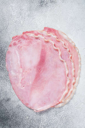 Fresh pork ham slices on kitchen table. White background. Top viewの写真素材