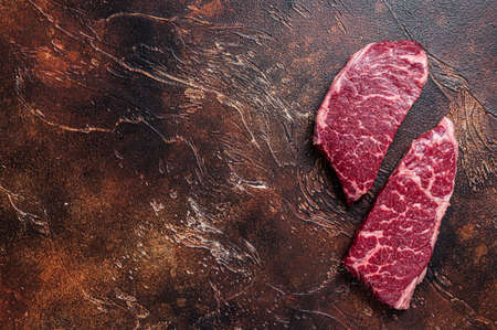 Raw Denver steak Marble beef meat. Dark background. Top view. Copy space.の写真素材