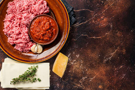 Raw lasagna ingredients and products for pasta. Dark background. Top view. Copy spaceの写真素材