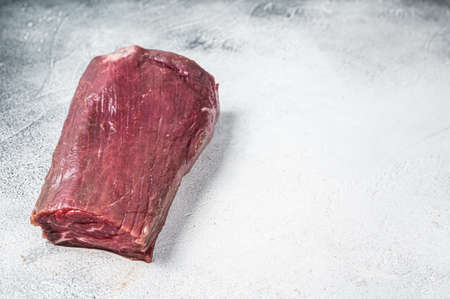 Beef Tenderloin raw meat on butcher table. White background. Top view. Copy spaceの写真素材