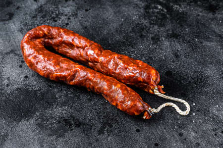 Spanish chorizo pork cured sausage. Black background. Top viewの写真素材