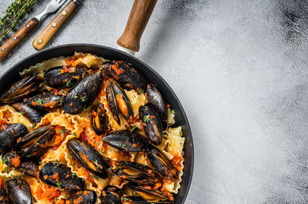Traditional italian seafood pasta with mussels, Spaghetti and tomato sauce. White background. Top view. Copy spaceの写真素材