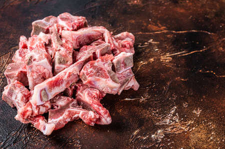 Raw meat on the bone diced for stew. Dark background. Top View. Copy spaceの写真素材