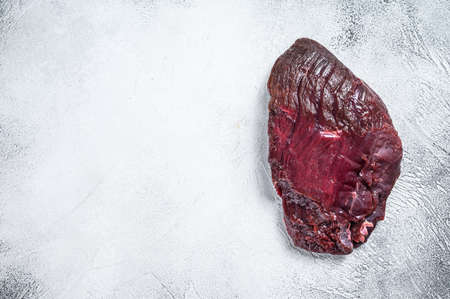 Venison raw deer meat on a table. White background. Top view. Copy spaceの写真素材