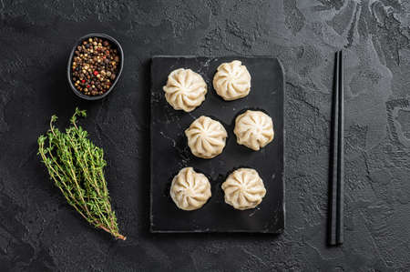 Chinese baozi dumplings on a marble board. Black background. Top viewの写真素材