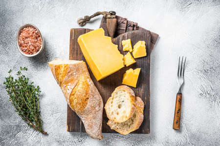 Gouda cheese with bread ready for cooking sandwich. White background. Top viewの写真素材