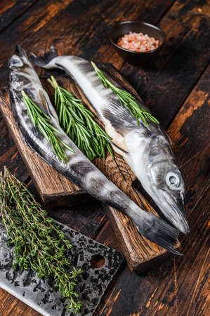 Whole fresh Raw icefish on a wooden cutting board. Wooden background. Top viewの写真素材