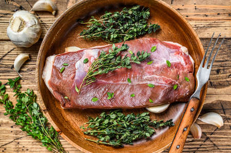 Raw uncooked poultry duck meat breast fillet with herbs. wooden background. Top viewの写真素材