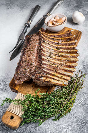 Charcoal Grilled French rack of Lamb Ribs Chops on cutting board. White background. Top viewの写真素材