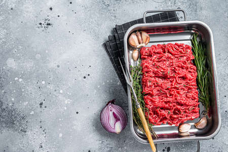 Fresh Raw Ground, Mince, minced beef and lamb meat. Gray background. Top view. Copy space