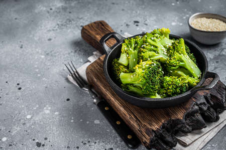 Green boiled broccoli cabbage in pan. Gray background. Top view. Copy spaceの写真素材