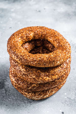 Turkish Bagel Simit with sesame traditional pastry. Gray background. Top view