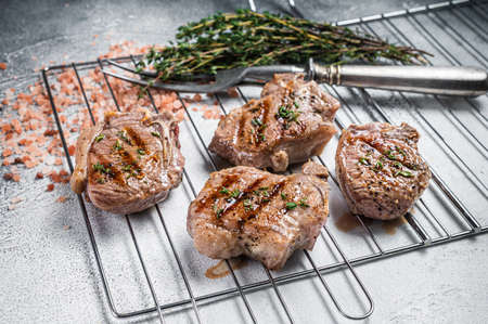 BBQ grilled lamb loin steaks, chops cutlets on grill. White background. Top viewの写真素材