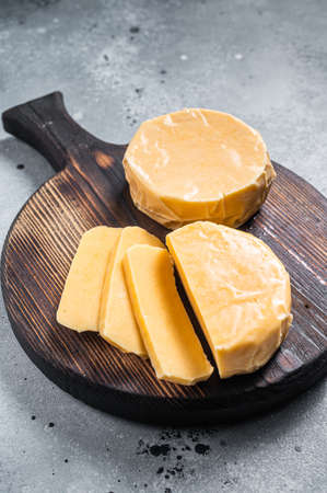 Halloumi sliced cheese on kitchen table. Gray background. Top view