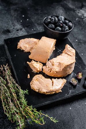 Foie gras duck liver pate and fresh blueberry. Black background. Top viewの写真素材