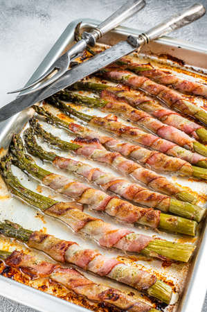 Asparagus Wrapped in Bacon on a Barbecue tray. White background. Top viewの写真素材