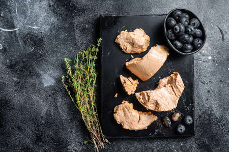 Foie gras duck liver pate and fresh blueberry. Black background. Top view. Copy spaceの写真素材