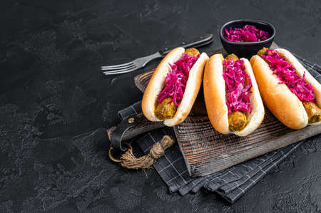 Homemade Vegan hot-dog with meatless Vegetarian sausage and cabbage. Black background. Top view. Copy spaceの写真素材