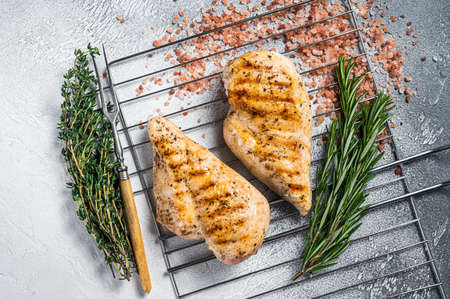 Grilled chicken breasts steaks cooked on a summer BBQ. Gray background. Top viewの写真素材