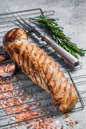 Grilled pork tenderloin fillet meat on grill. Gray background. Top viewの写真素材