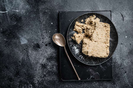 Homemade sunflower halva with honey. Black background. Top view. Copy spaceの写真素材