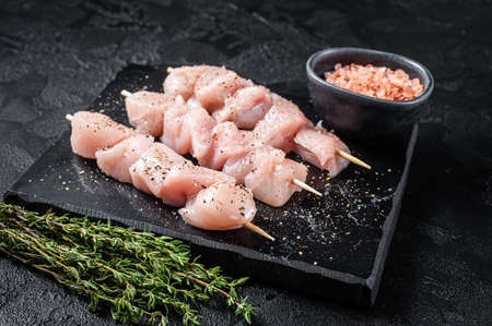 Raw chicken meat shish kebab skewers. Black background. Top viewの写真素材