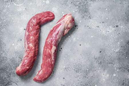 Raw pork tenderloin fillet meat. Gray background. Top view. Copy spaceの写真素材